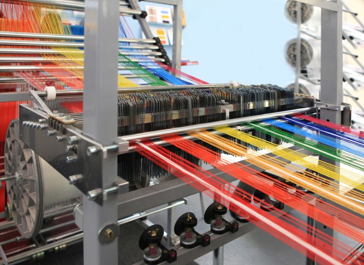 multi-colored yarns in the textile machine Andrews Ventilation Hire provides textile manufacturer with an extraction solution