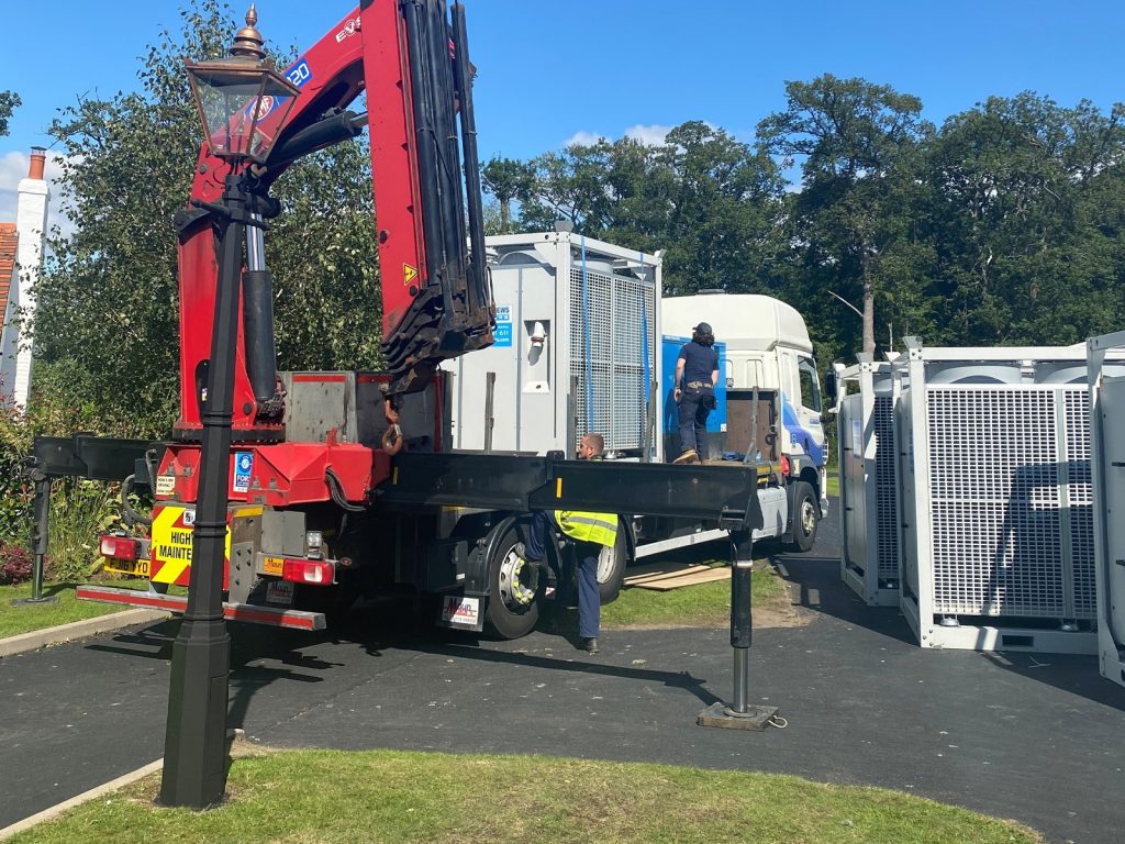 Four HPAC90 air conditioners positioned outside a large wedding marquee with ducting attached