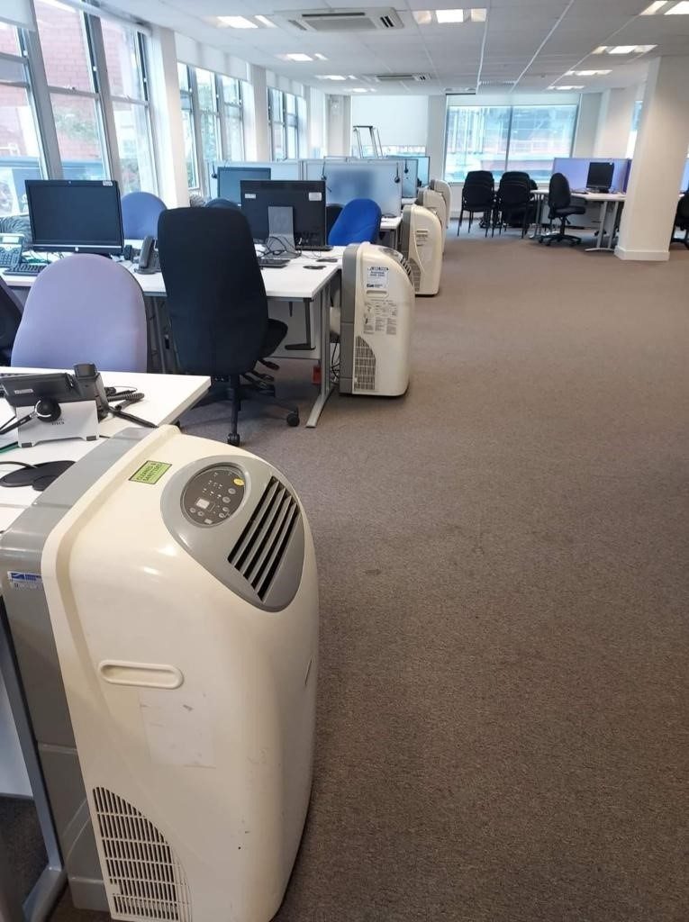Engineer assessing university building for temporary air conditioning installation