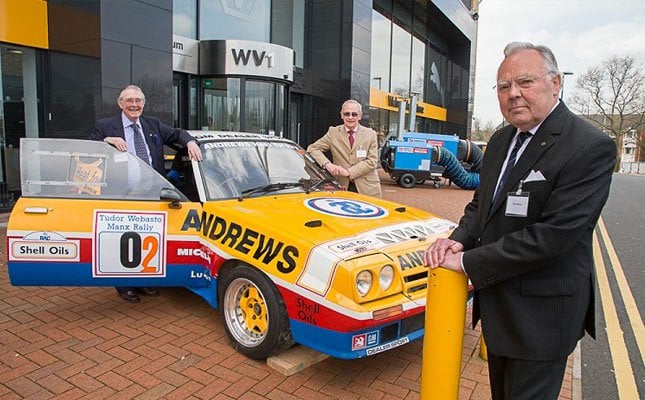 Russell Brookes, Mike Broad and John Andrews pose alongside a vintage rally car