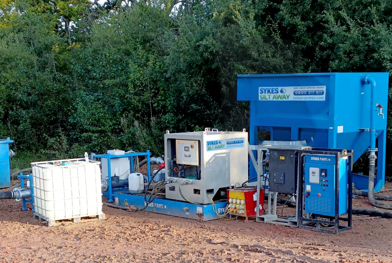 Sykes Pumps Silt Away system with chemical dosing and monitoring equipment used for lake dewatering and water treatment in a West Sussex quarry.