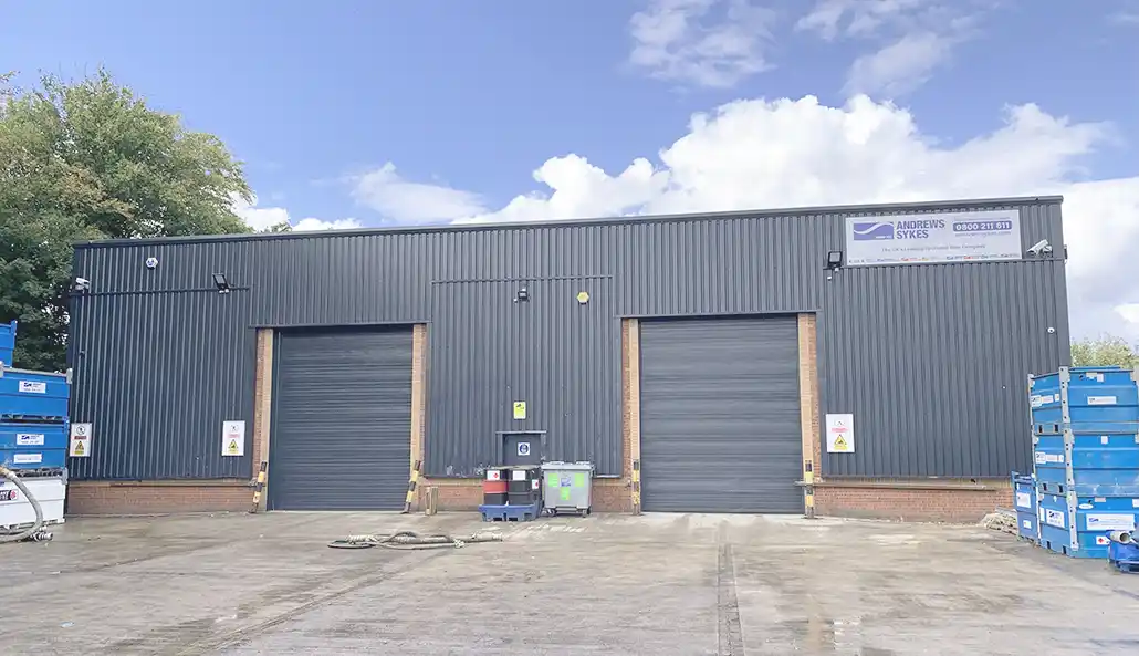 Front view of the Andrews Sykes North West depot in Irlam, Manchester, featuring large doors and customer access.